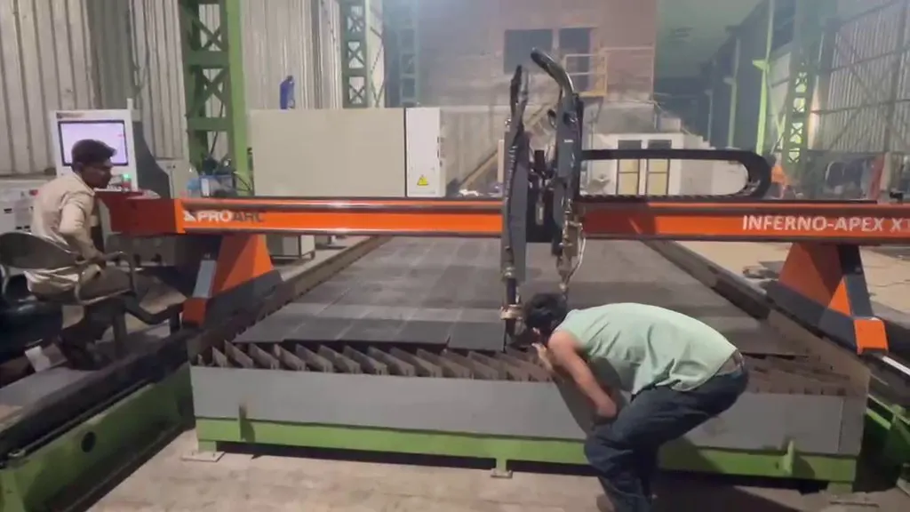 Operator monitoring the CNC plasma table