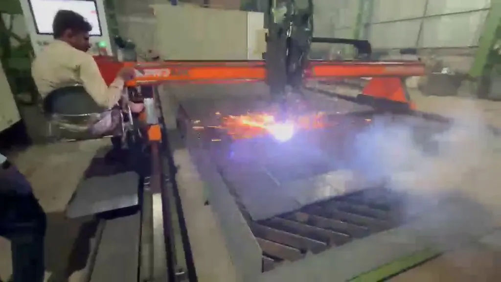 CNC plasma torch cutting a steel plate